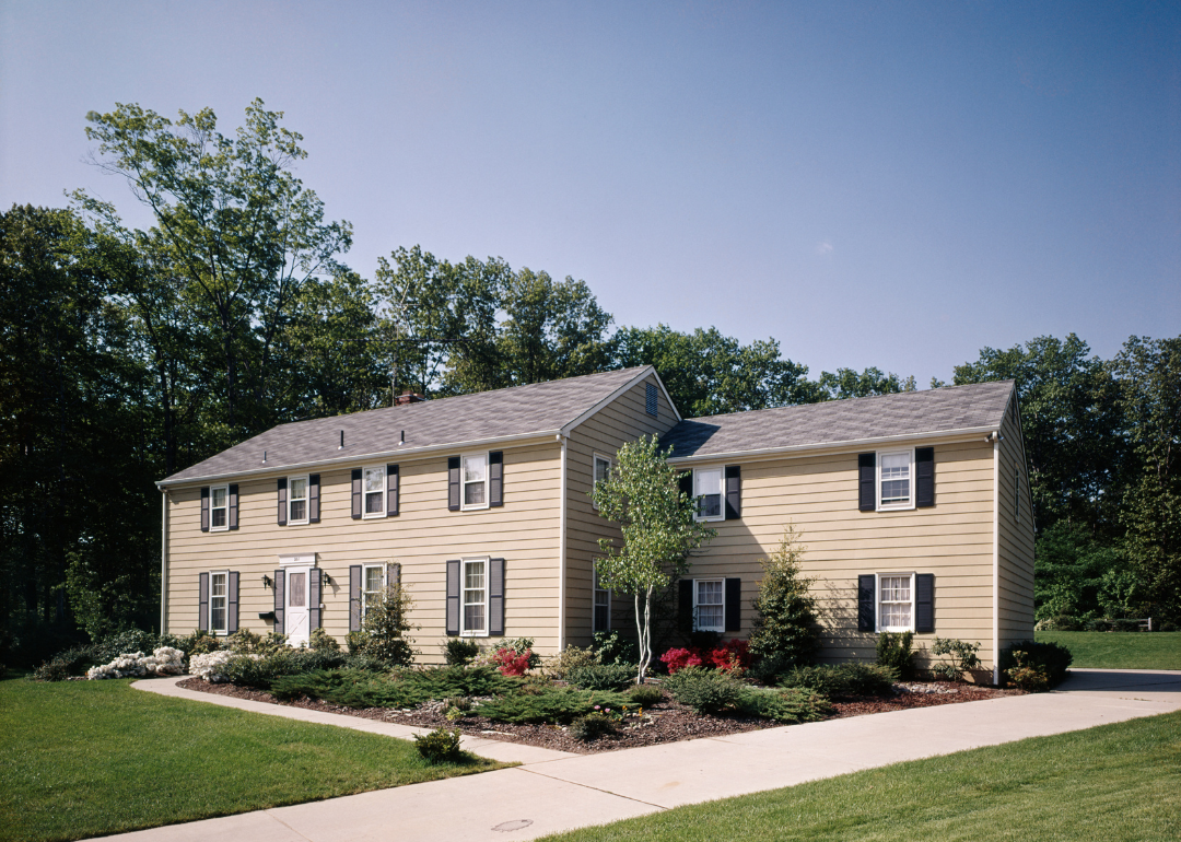 A two-story colonial tan home in 1990.