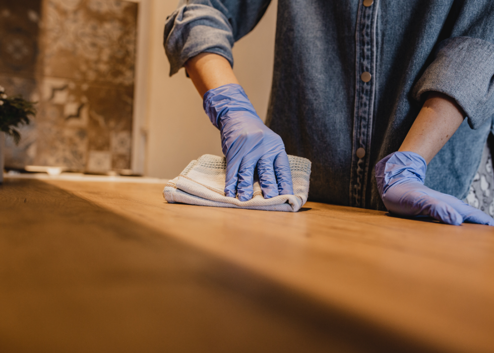 A person wiping a counter in their home