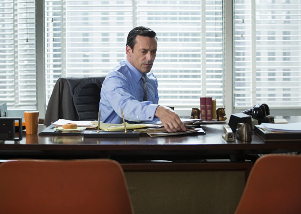 Jon Hamm sits behind his desk in a scene in a 2007 episode of the TV show, Mad Men.