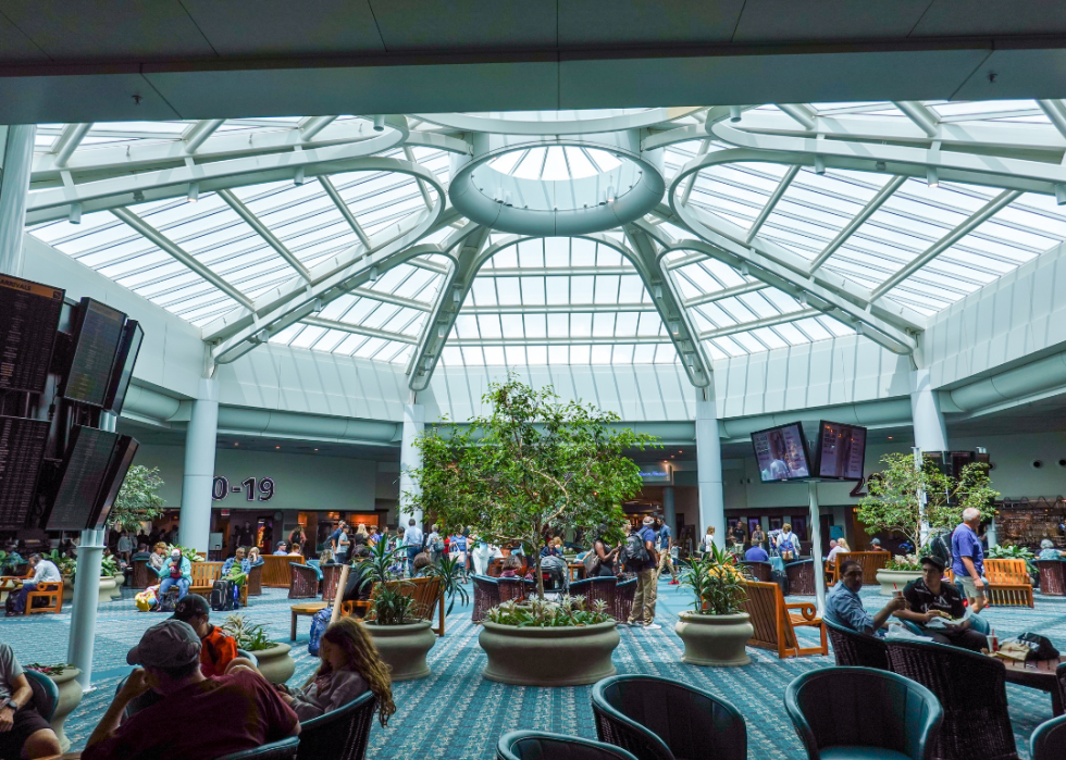 People waiting in an atrium area of Orlando International Airport