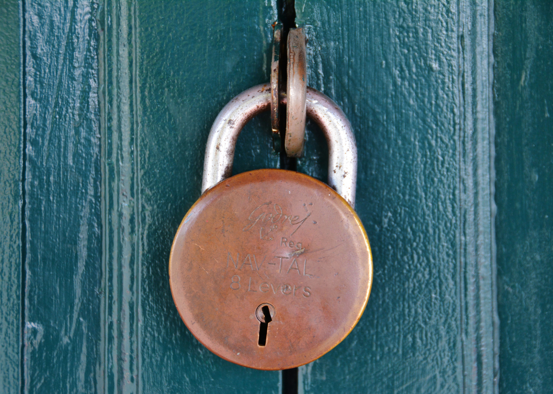 A padlock on a wooden door.