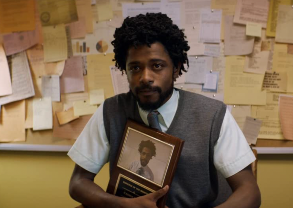 LaKeith Stanfield holds an award plaque during in the film, Sorry to Bother You.