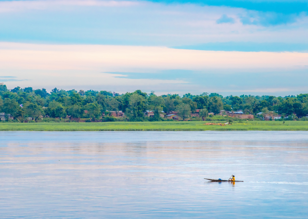 A fisherman rowing a boat on the Ubangi River, fishing in Bangui, the capital of Central African Republic