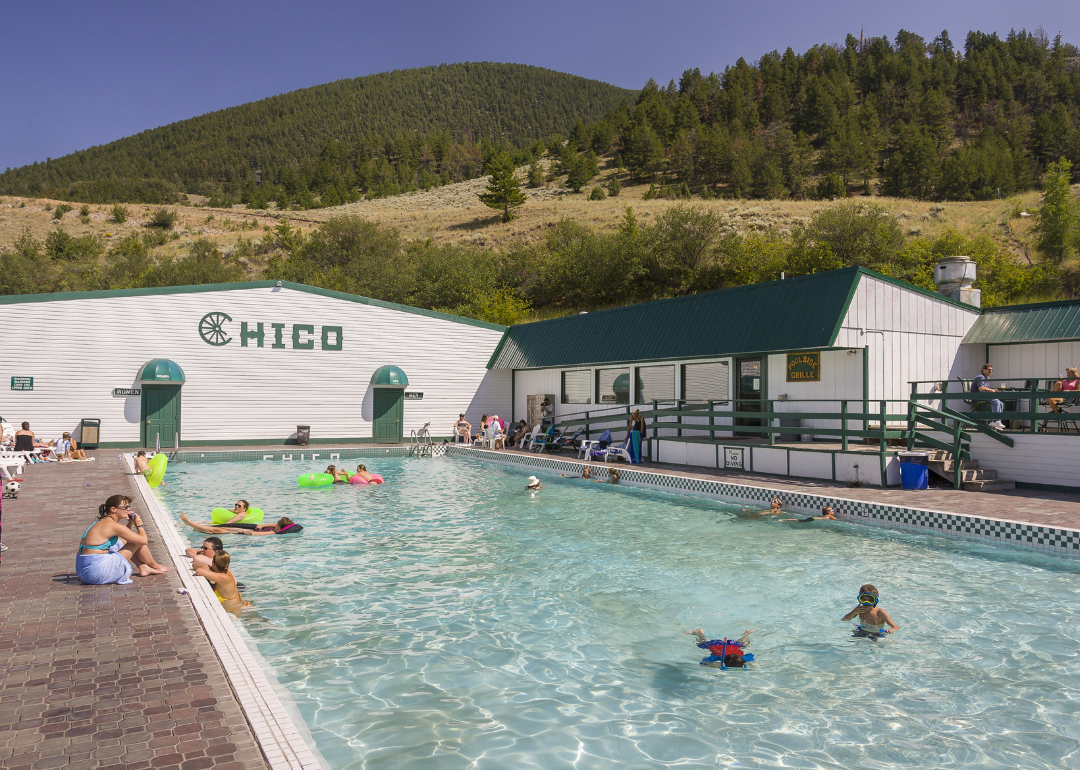 Guests swimming in a geothermic heated pool at Chico Hot Springs resort.