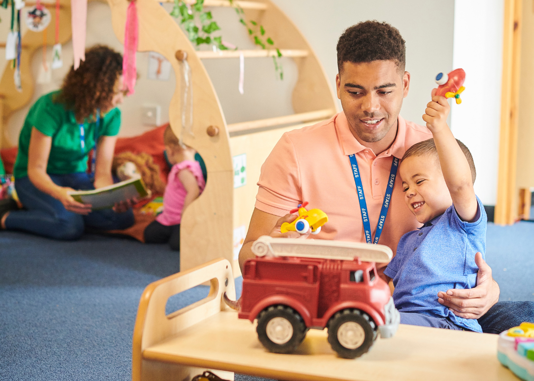 A child and a daycare teacher playing together