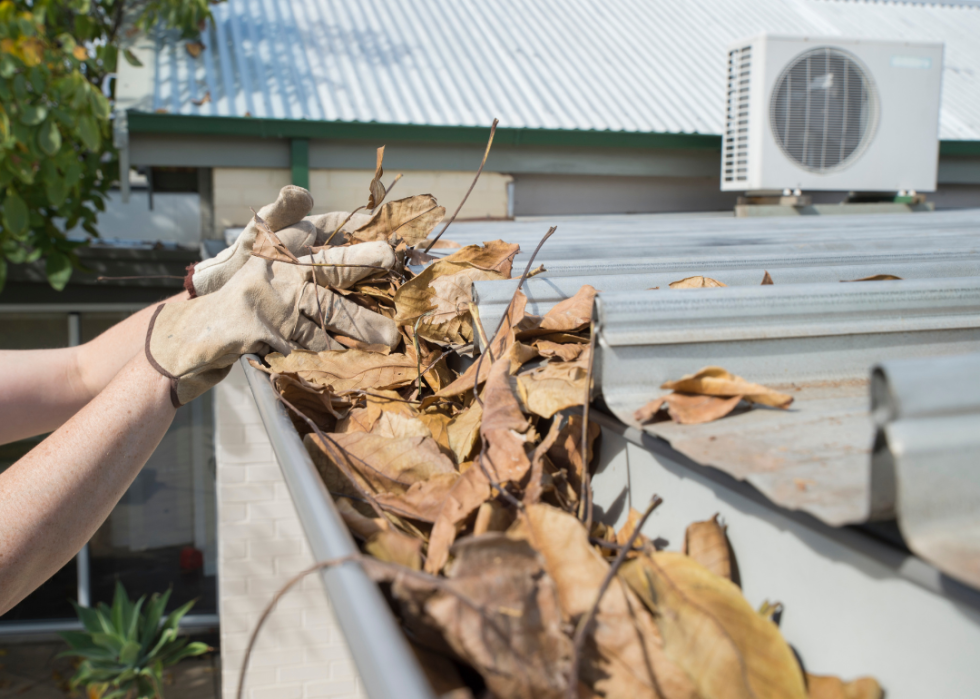 A person cleaning out their gutters