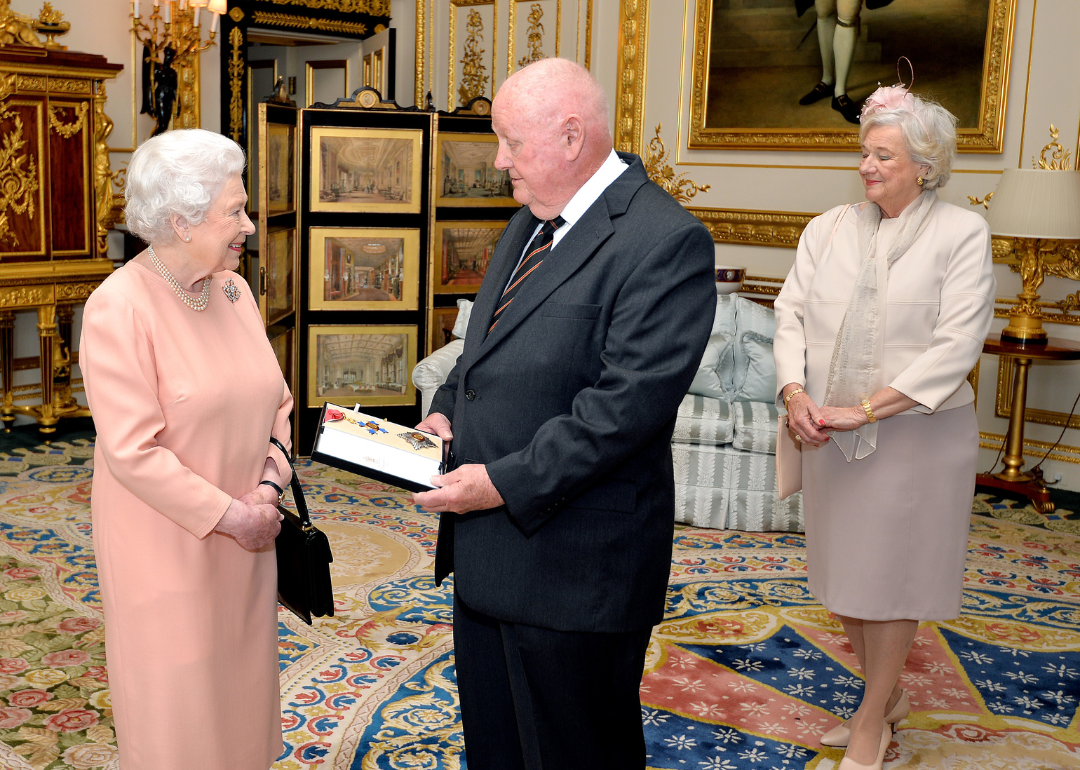 Queen Elizabeth II presenting American businessman John Mars with an honorary Knighthood at Windsor Castle on April 29, 2015 in Windsor, England.