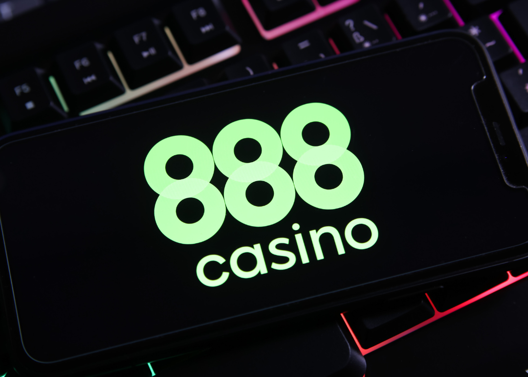 A mobile phone open to the 888 logo.