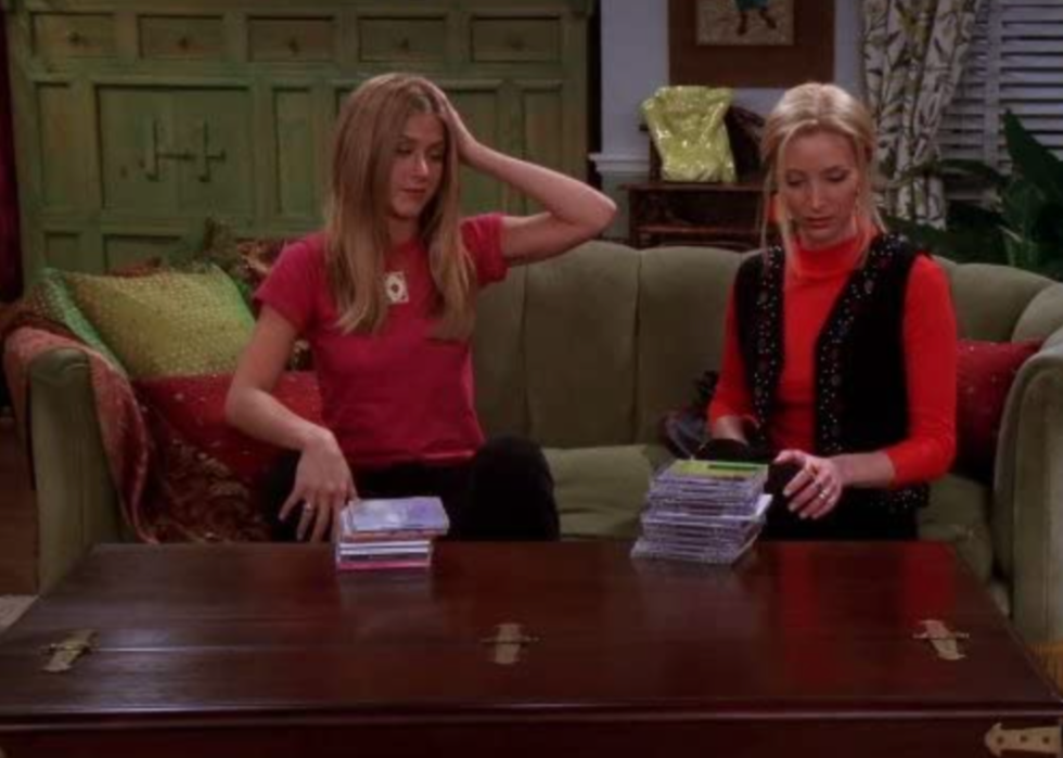Jennifer Aniston and Lisa Kudrow sitting in front of the apothecary table in Friends