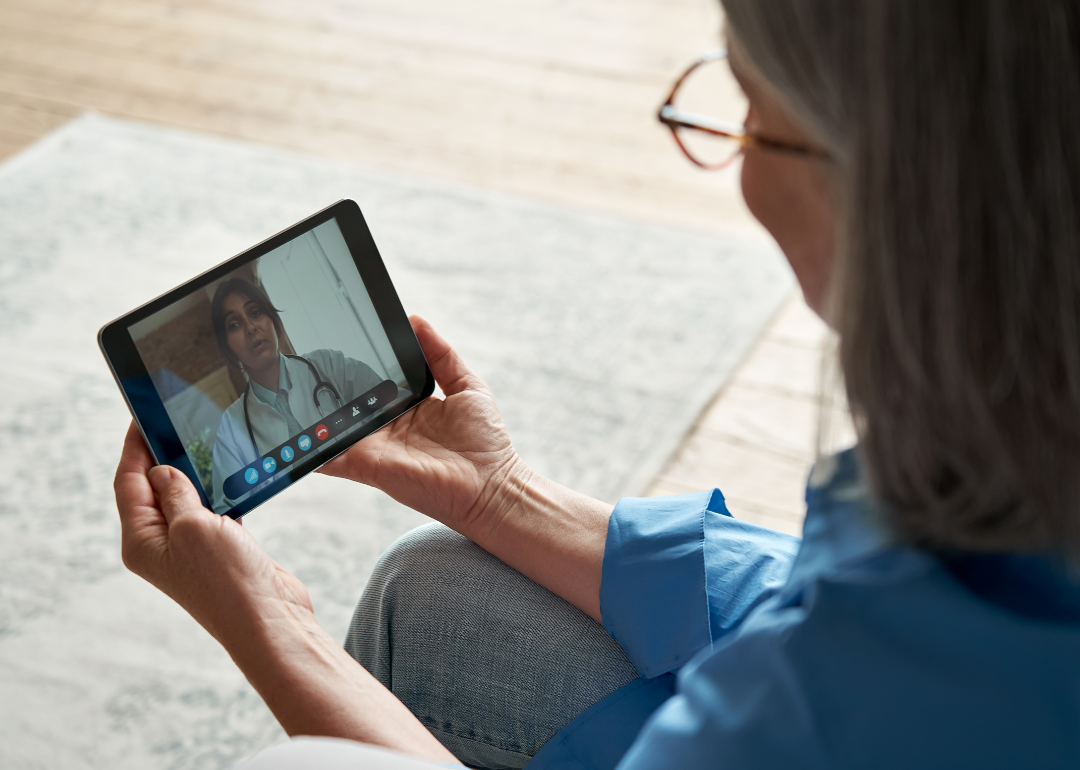 An elderly employee at a telehealth appointment