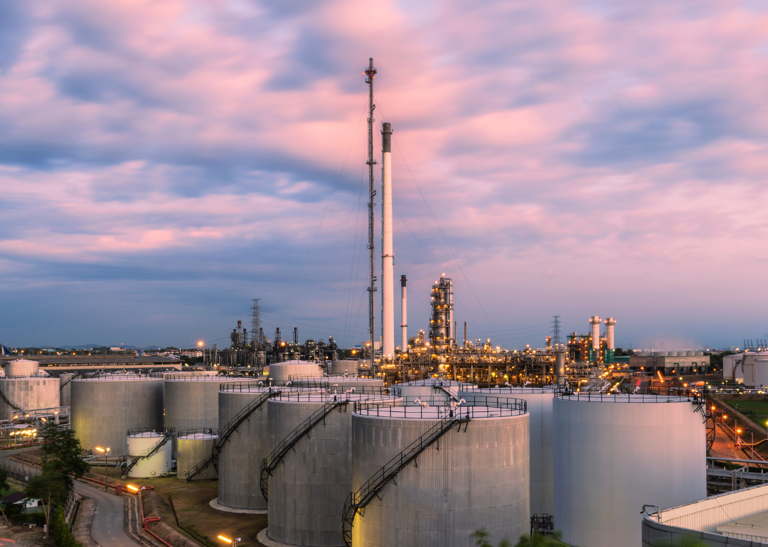 Large industrial oil tanks at sunset.