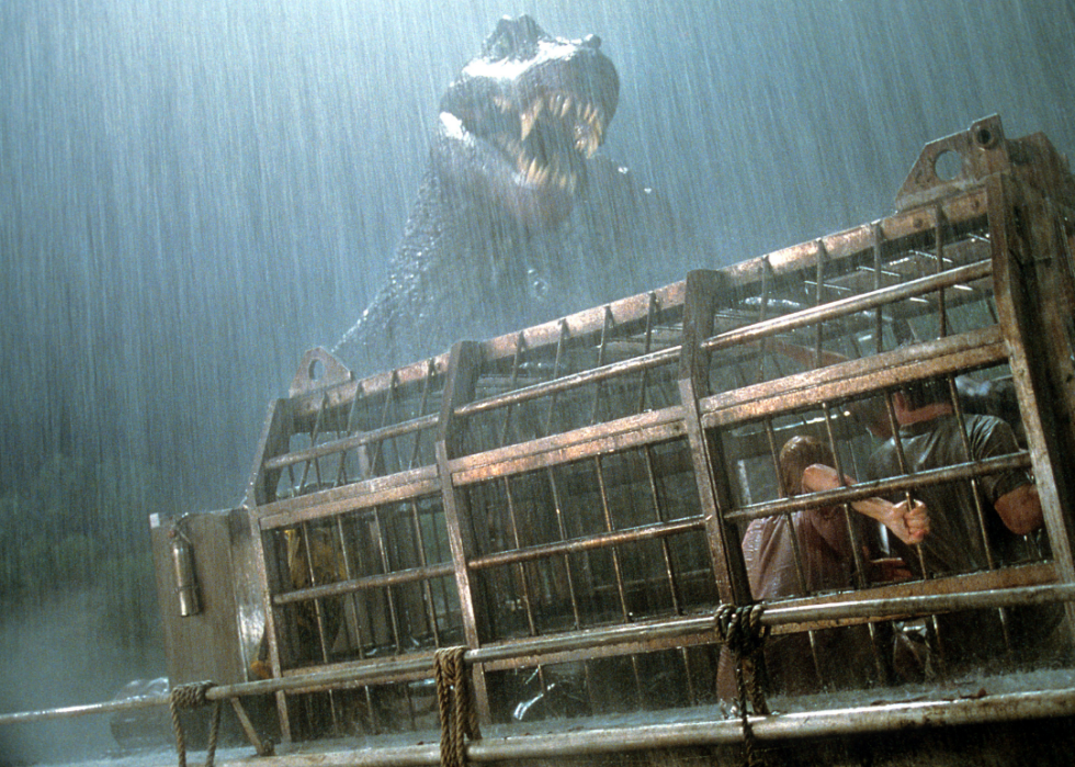 A T. rex attacking people in a cage in “Jurassic Park III”