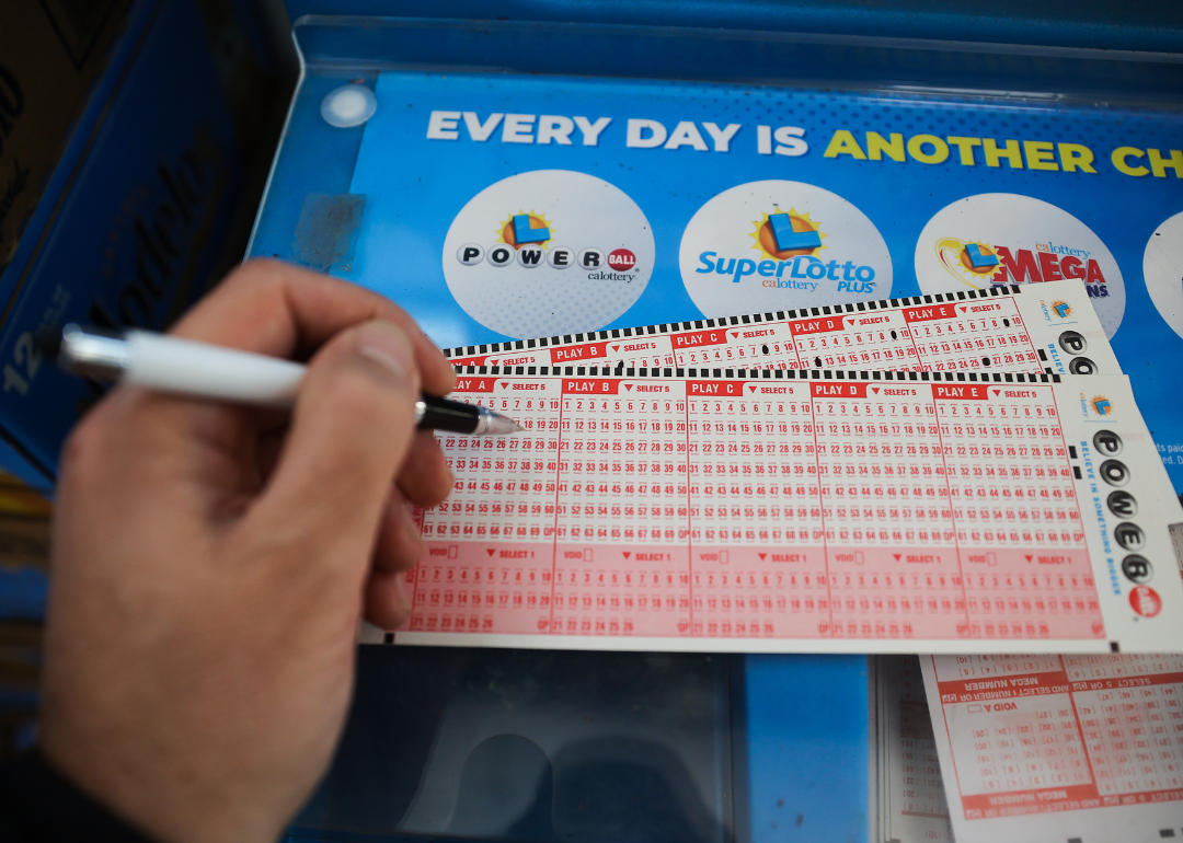 A person filling out a Powerball ticket.
