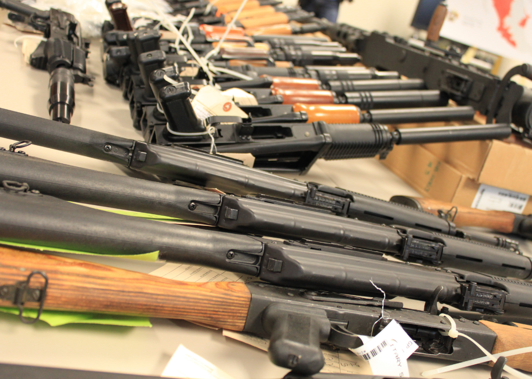 Guns, handguns, AK-47s and .50 caliber rifles, on display.