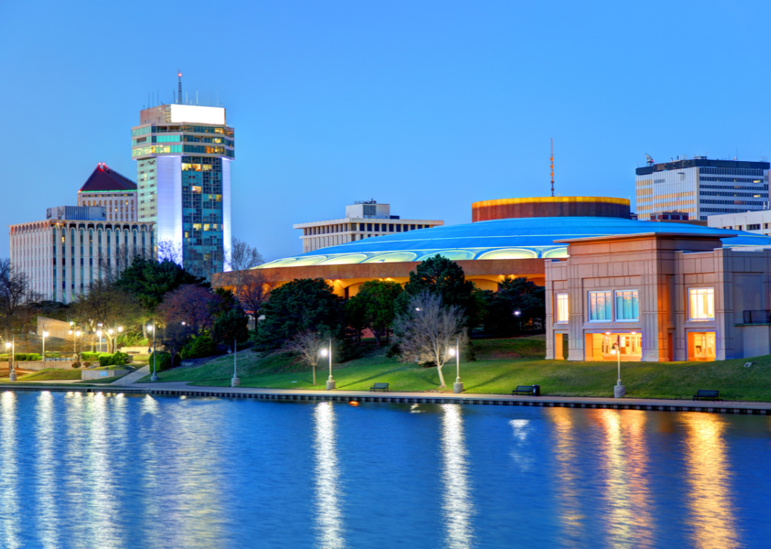 Buildings on the river in Witchita with bright lights.