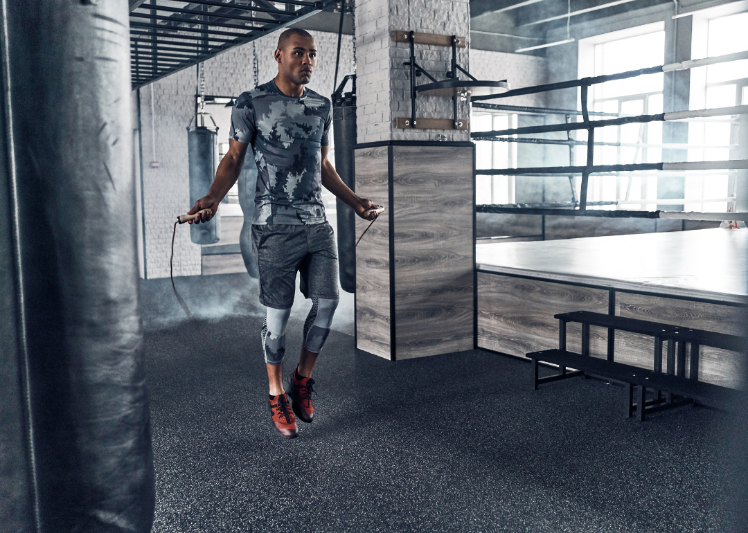 A young man jumping rope at the gym