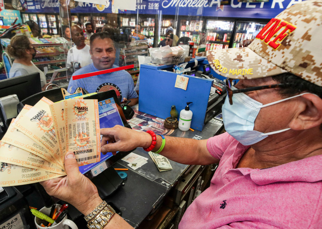 A cashier selling $200 worth of Mega Millions lottery tickets.