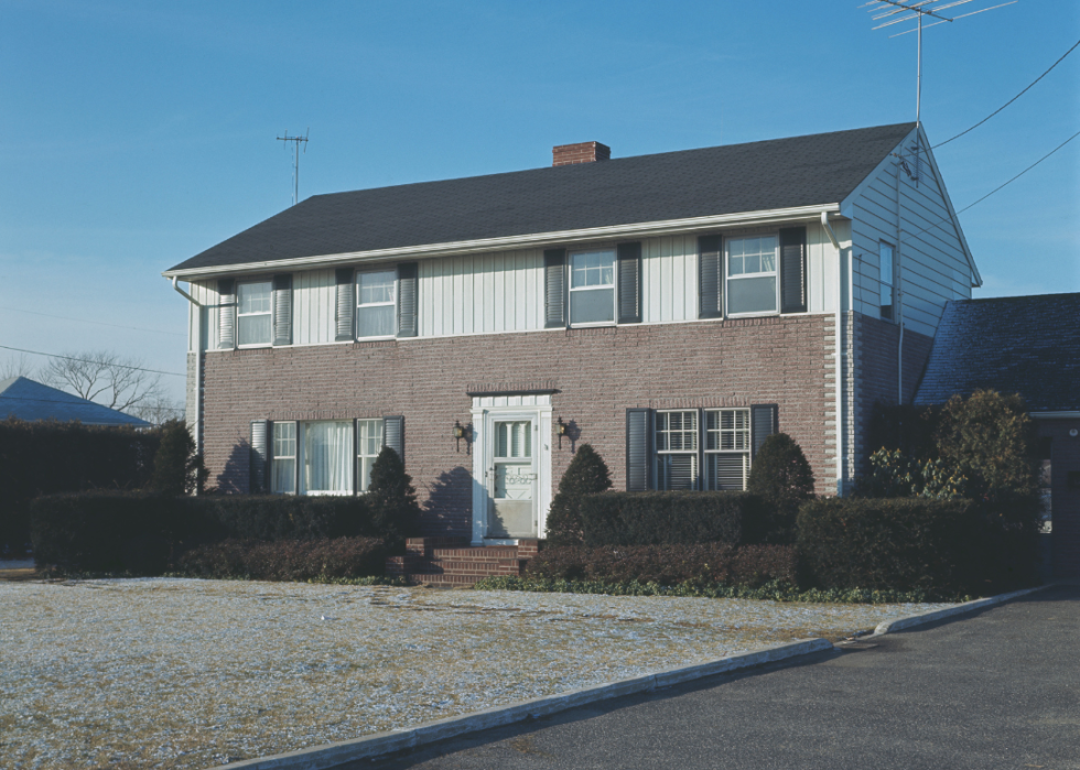 A wooden frame-type house converted to a semi-brick house using volcanic lava clip-on bricks in 1967.