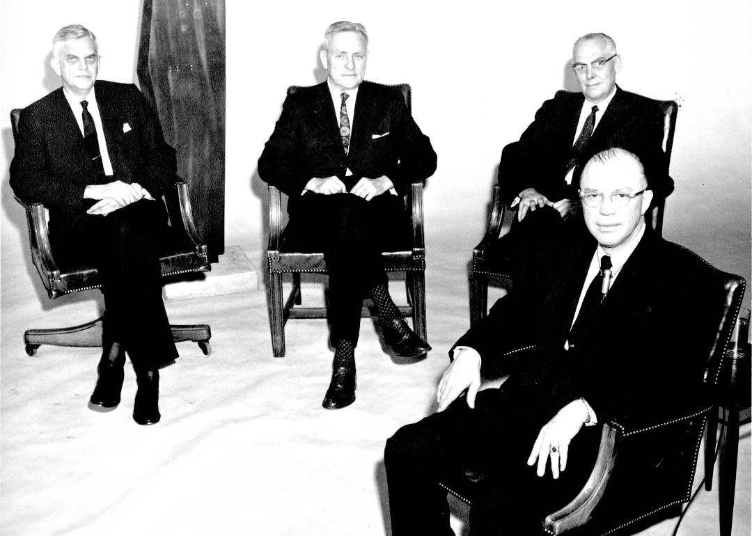 Johns Hopkins University President Milton S. Eisenhower seated with guests from the Ford Foundation discussing the Fund for the Advancement of Education.