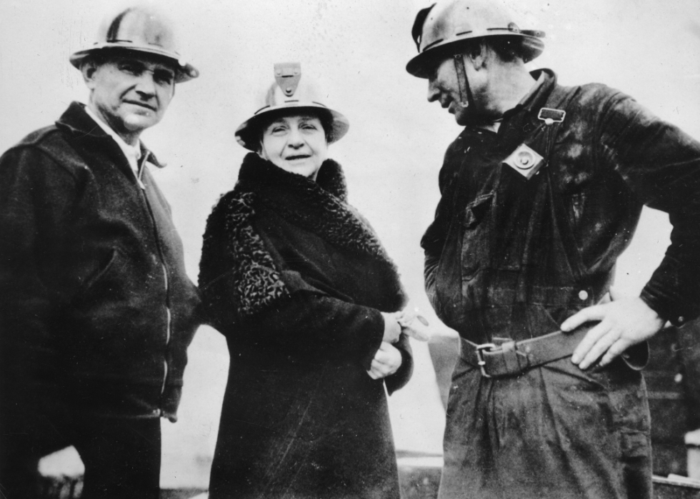 Frances Perkins with two workers at the construction site for the Golden Gate Bridge