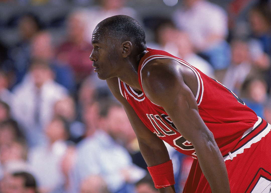 Michael Jordan, #23 of the Chicago Bulls, resting on the court during a game.