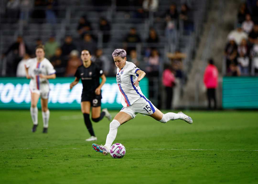 Megan Rapinoe #15 of OL Reign kicking the ball in a game against Angel City FC at BMO Stadium on April 19, 2023, in Los Angeles, California.
