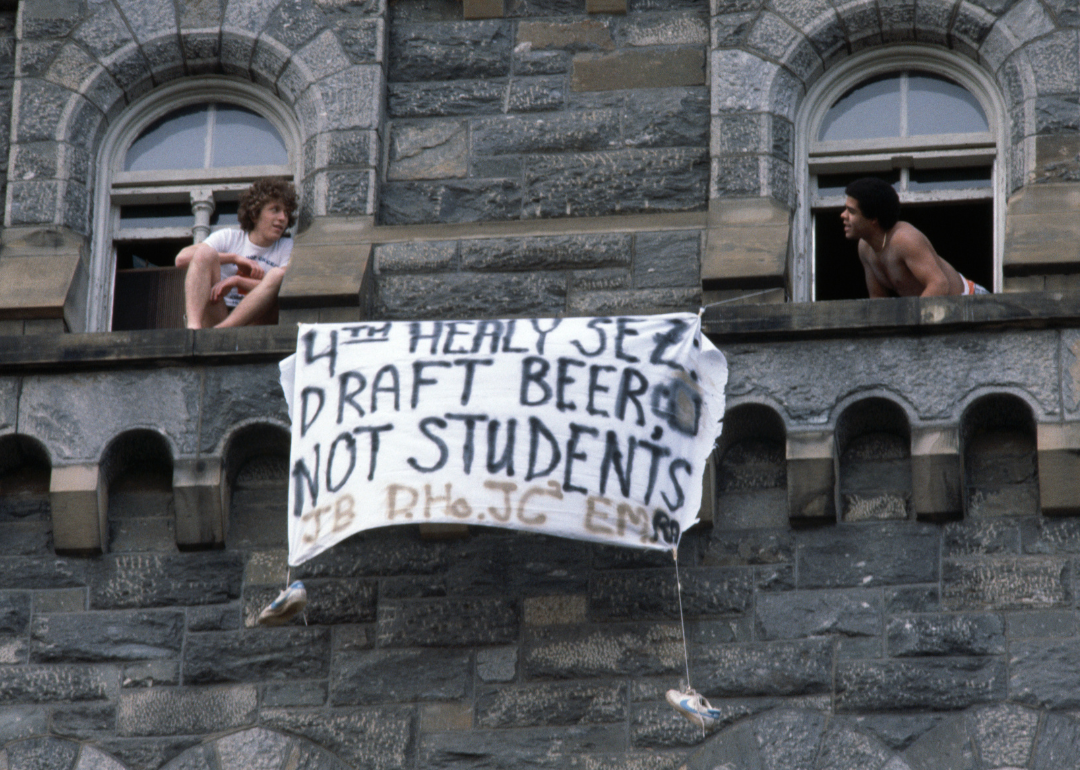 A sign protesting the Vietnam War and draft hanging from the windows of a dorm. 