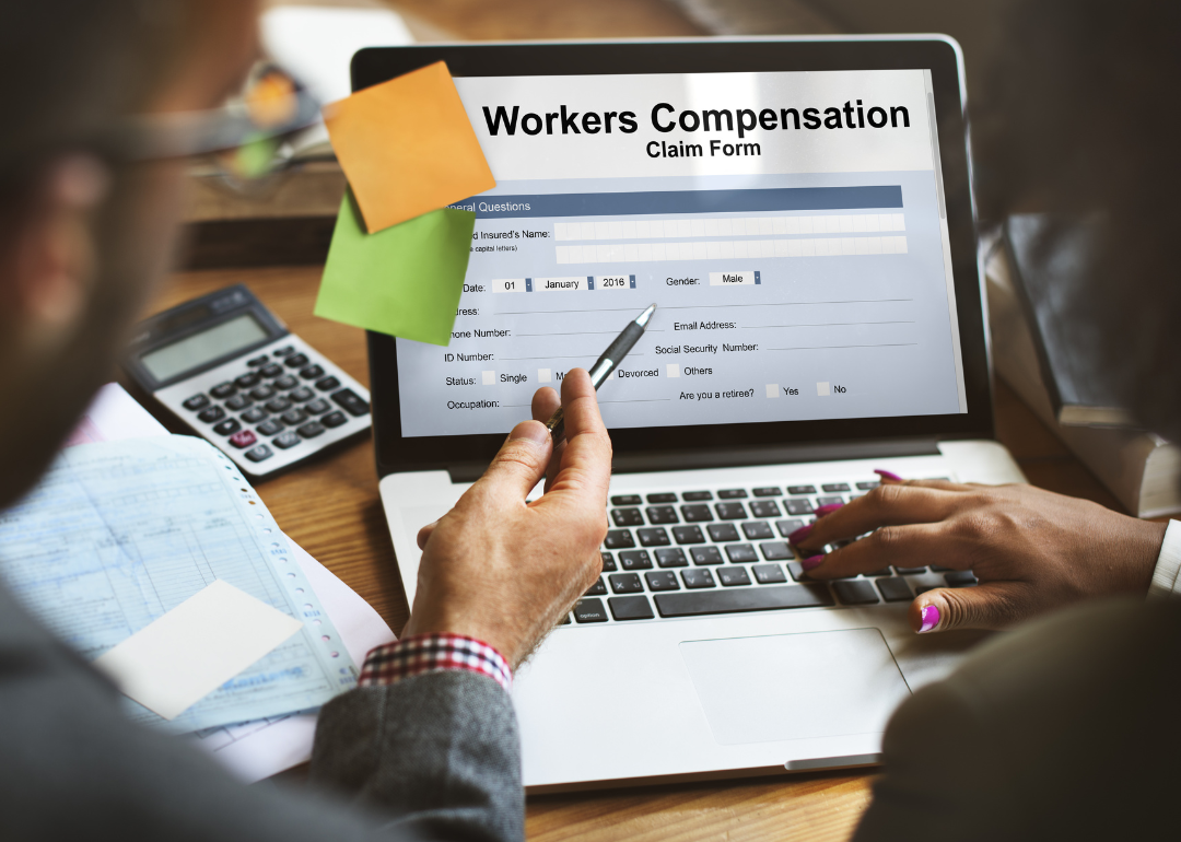 Two people completing a worker's compensation claim form