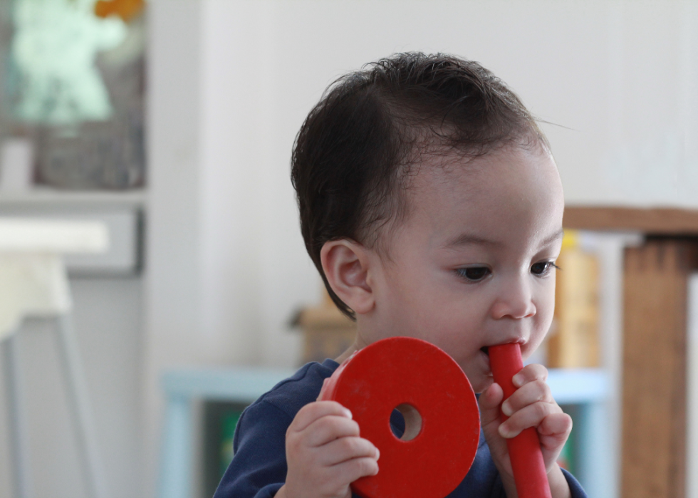 A child playing with an unsafe toy