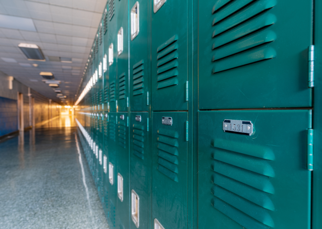 A hallway lined with green lockers.