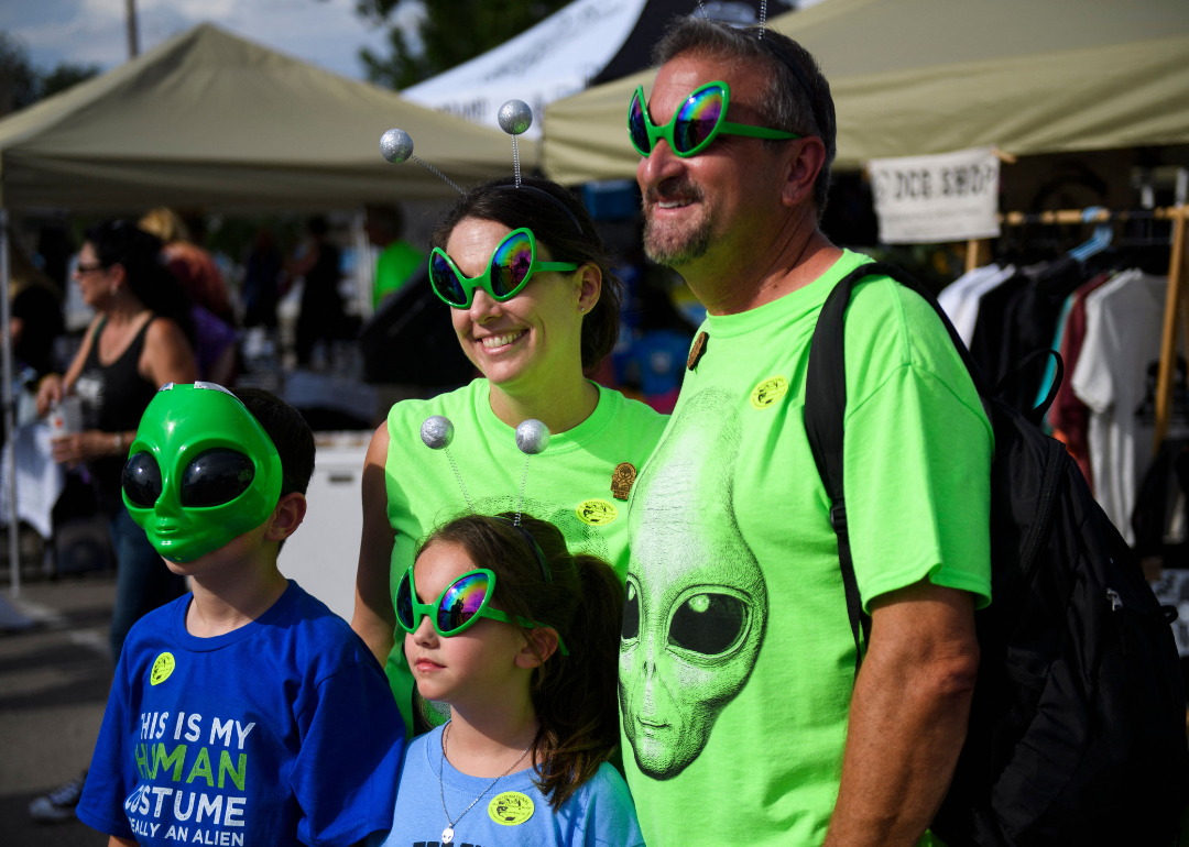 A family wearing alien sunglasses and t-shirts during an interview at the Roswell UFO Festival on July 2, 2021.