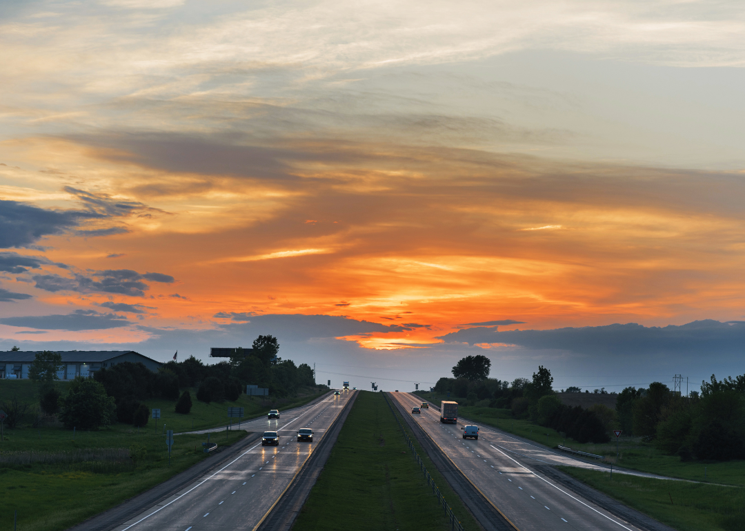 The I-80 highway in Iowa with a sunset in the background.