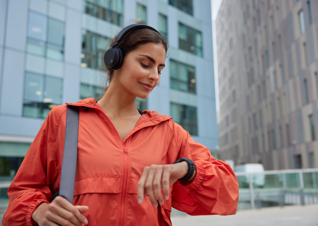 A person checking their smartwatch while on the move