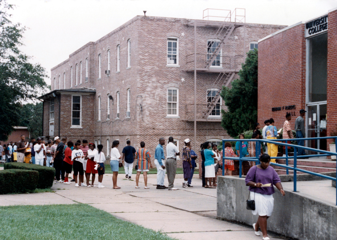 University students standing in line in front of campus registration office at Jackson State University in 1992.