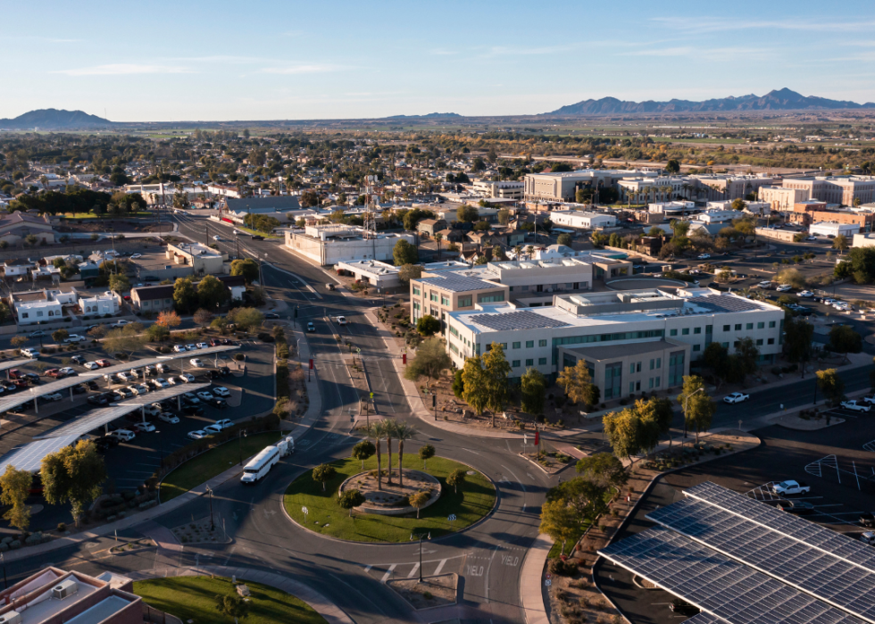 Aerial view of a city surrounded by mountains.