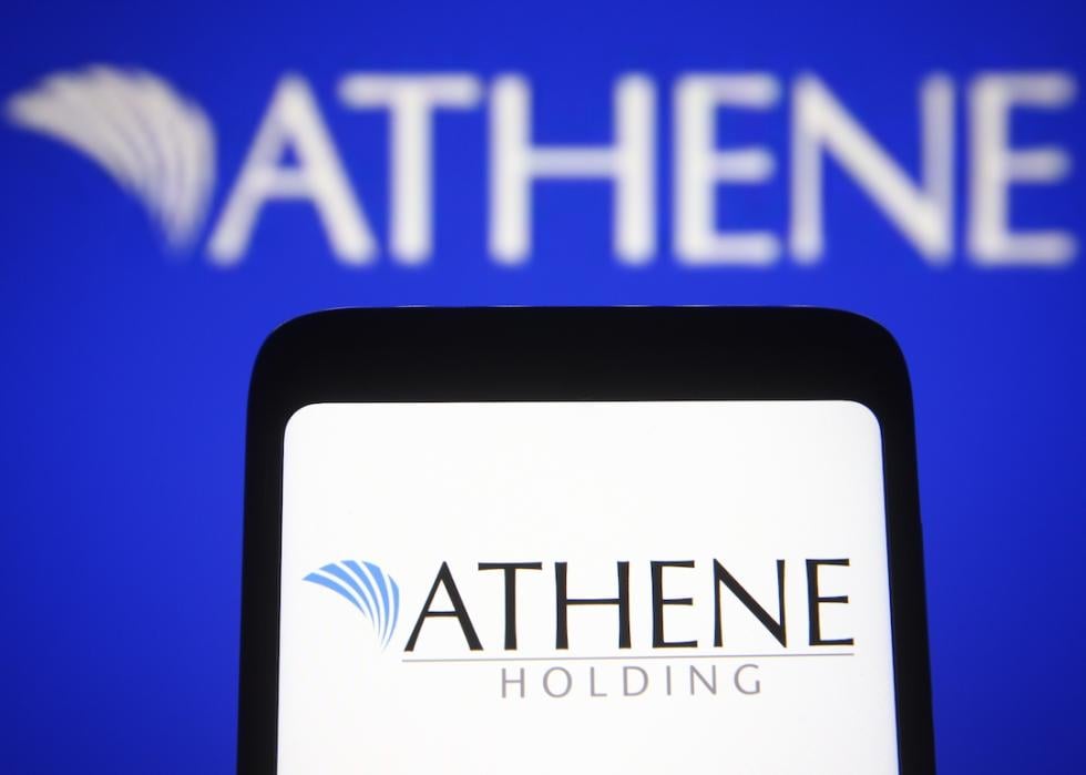 The Athene Holding logo on a smartphone and a PC screen.