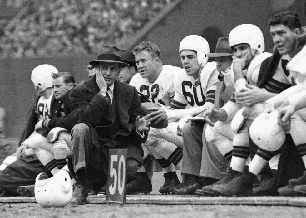 Coach Paul Brown with players on the field.