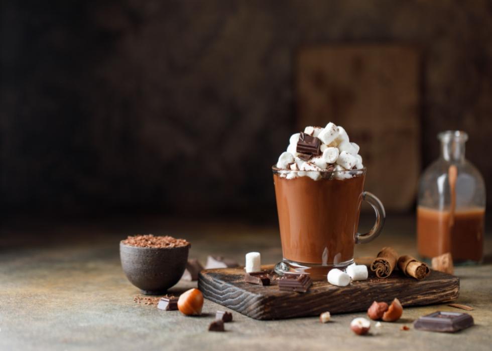 A chocoate Christmas drink in a glass mug.