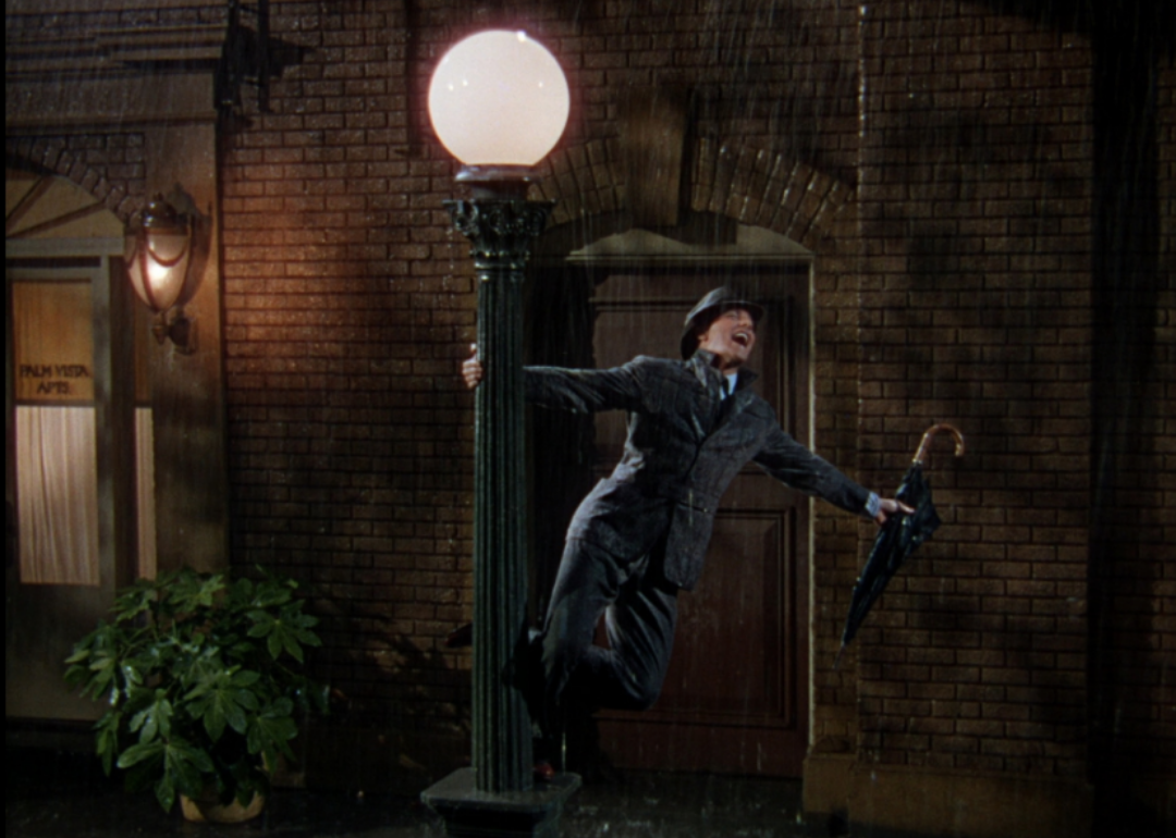 Gene Kelly dancing and singing in the rain.