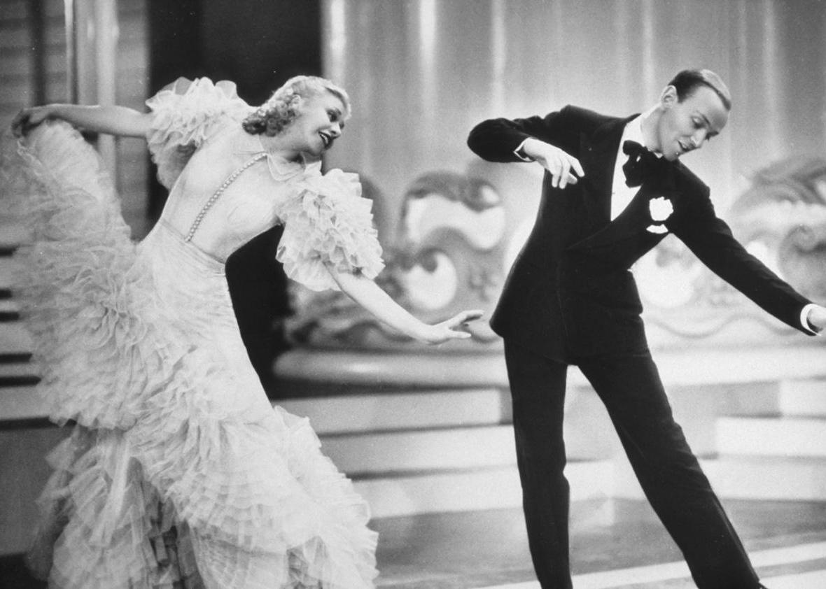 Fred Astaire and Ginger Rogers dancing on a stage.