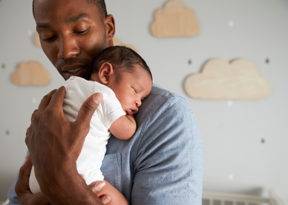 A father holding a newborn.