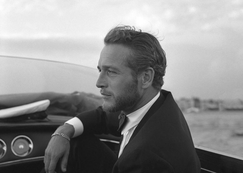 A young Paul Newman in a car.