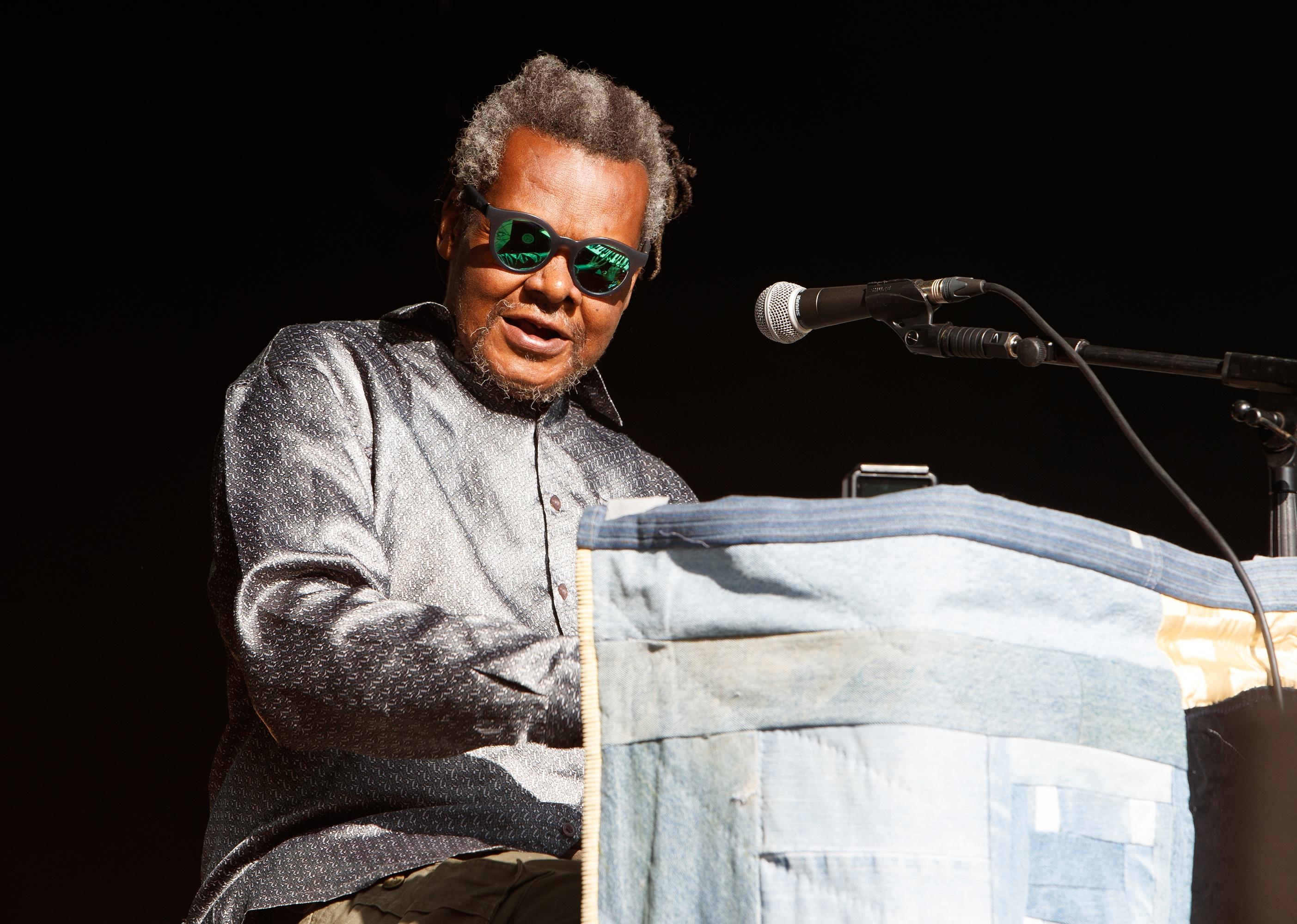 Lonnie Holley performing onstage.