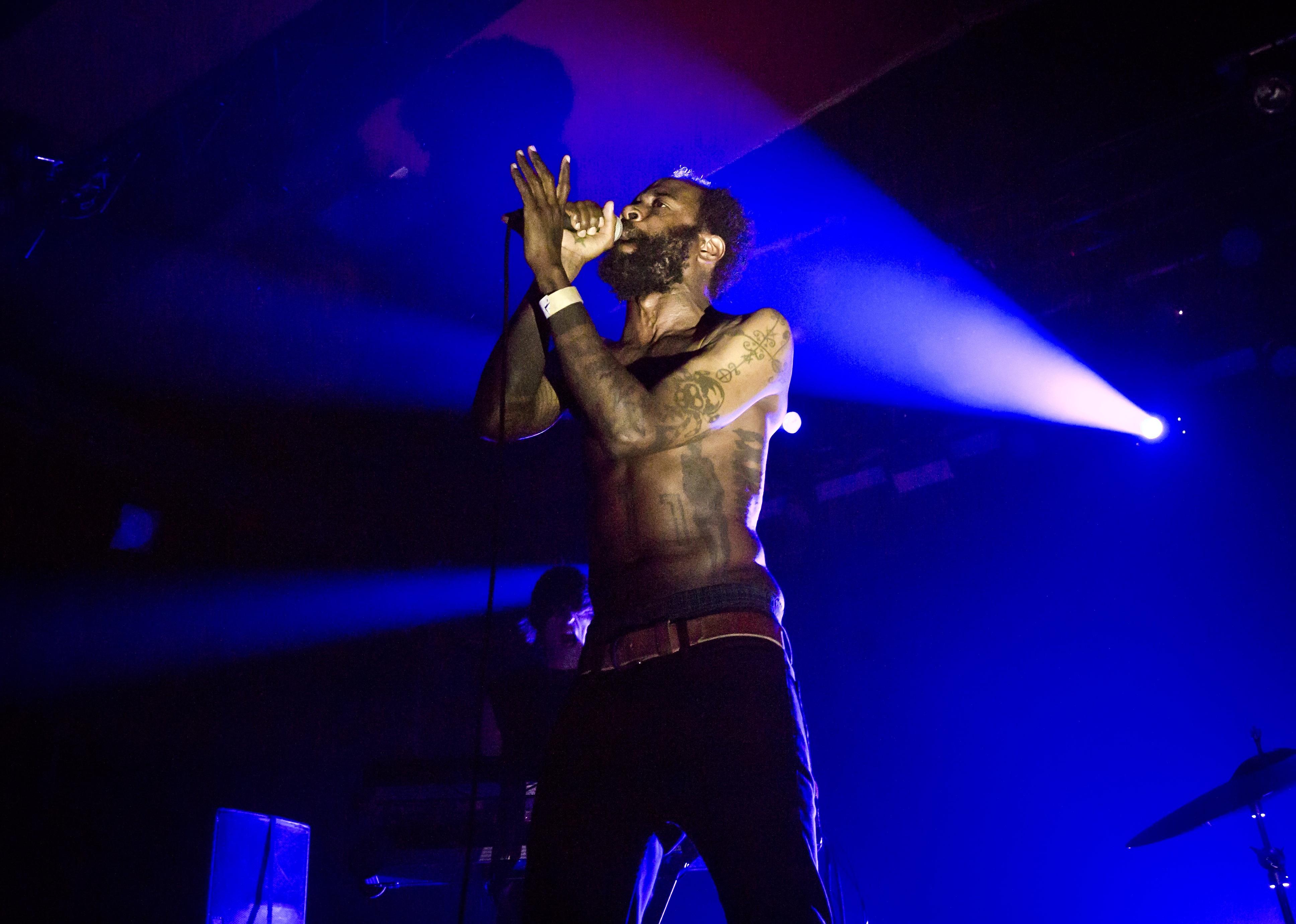 Death Grips performing onstage.