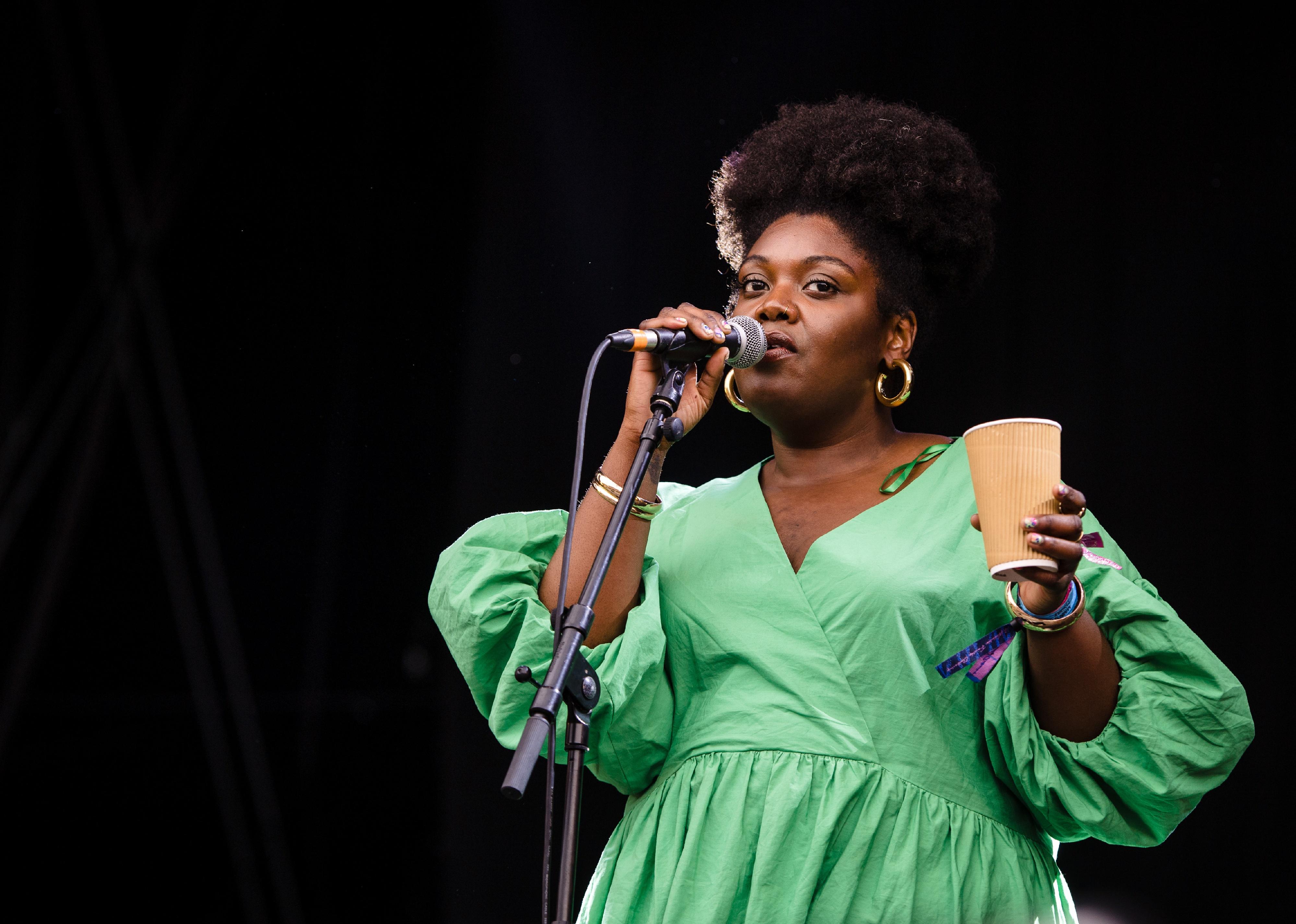 Yazmin Lacey performing in a green dress.