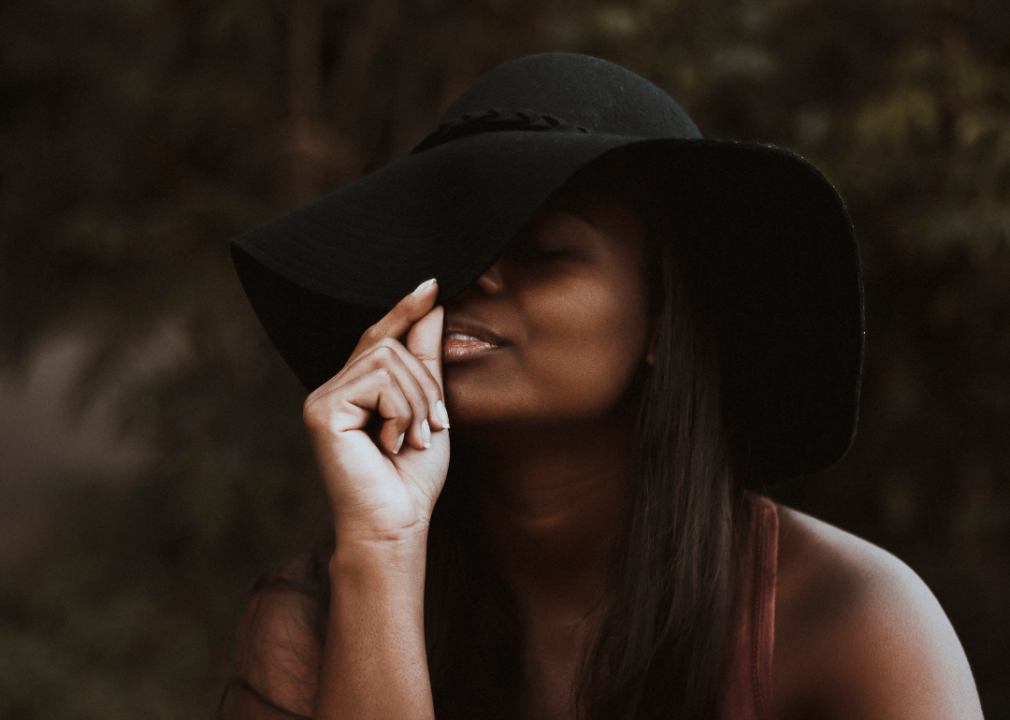 A model with a hat poses for a photo.