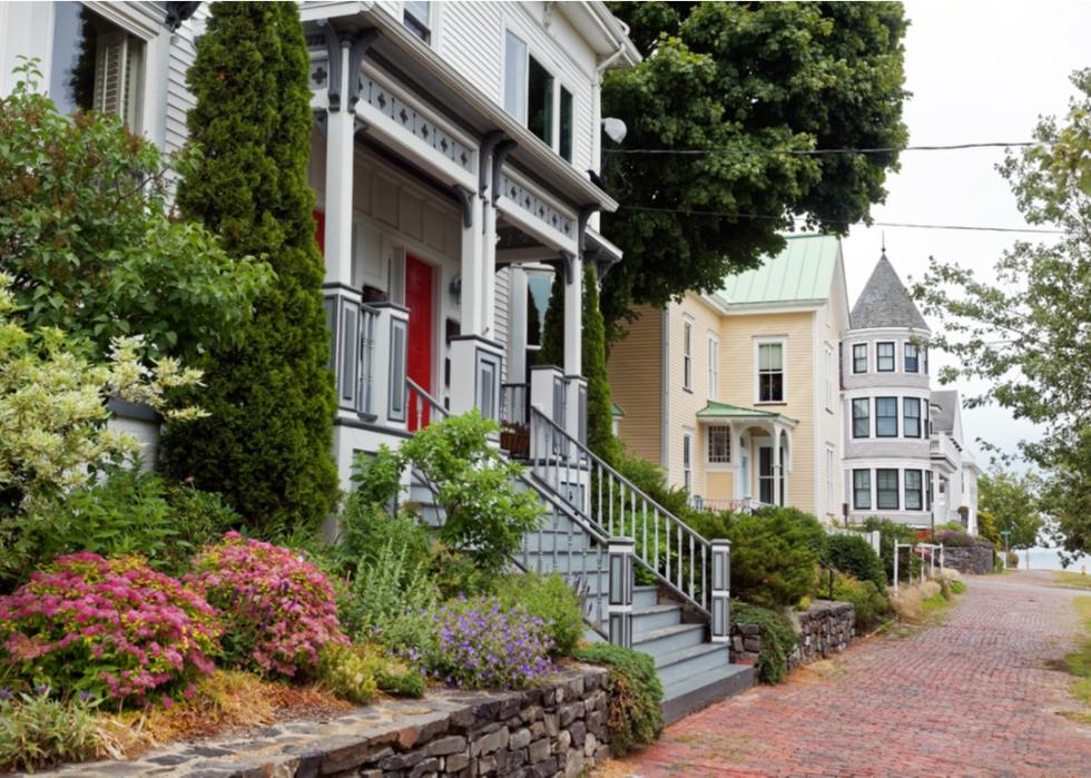 Victorian-style homes on a historic brick-covered street.