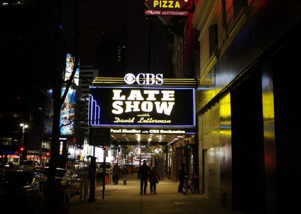 Theater at night bearing CBS marquee.