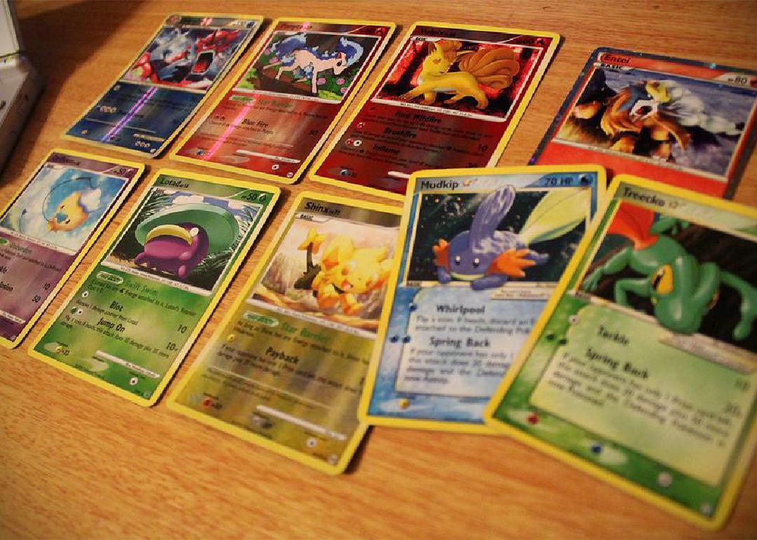 Pokemon cards spread out on a table. 