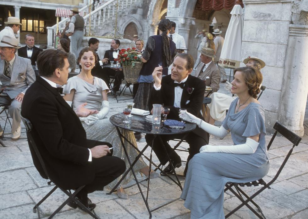 Ashley Judd, Kevin Kline, Kevin McNally, and Sandra Nelson have cocktails in a stone courtyard.